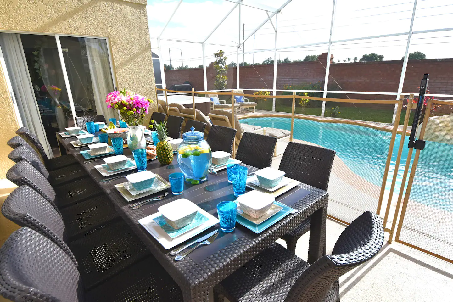 Outdoor melamine dinnerware and an extended poolside dining table for 12 people
