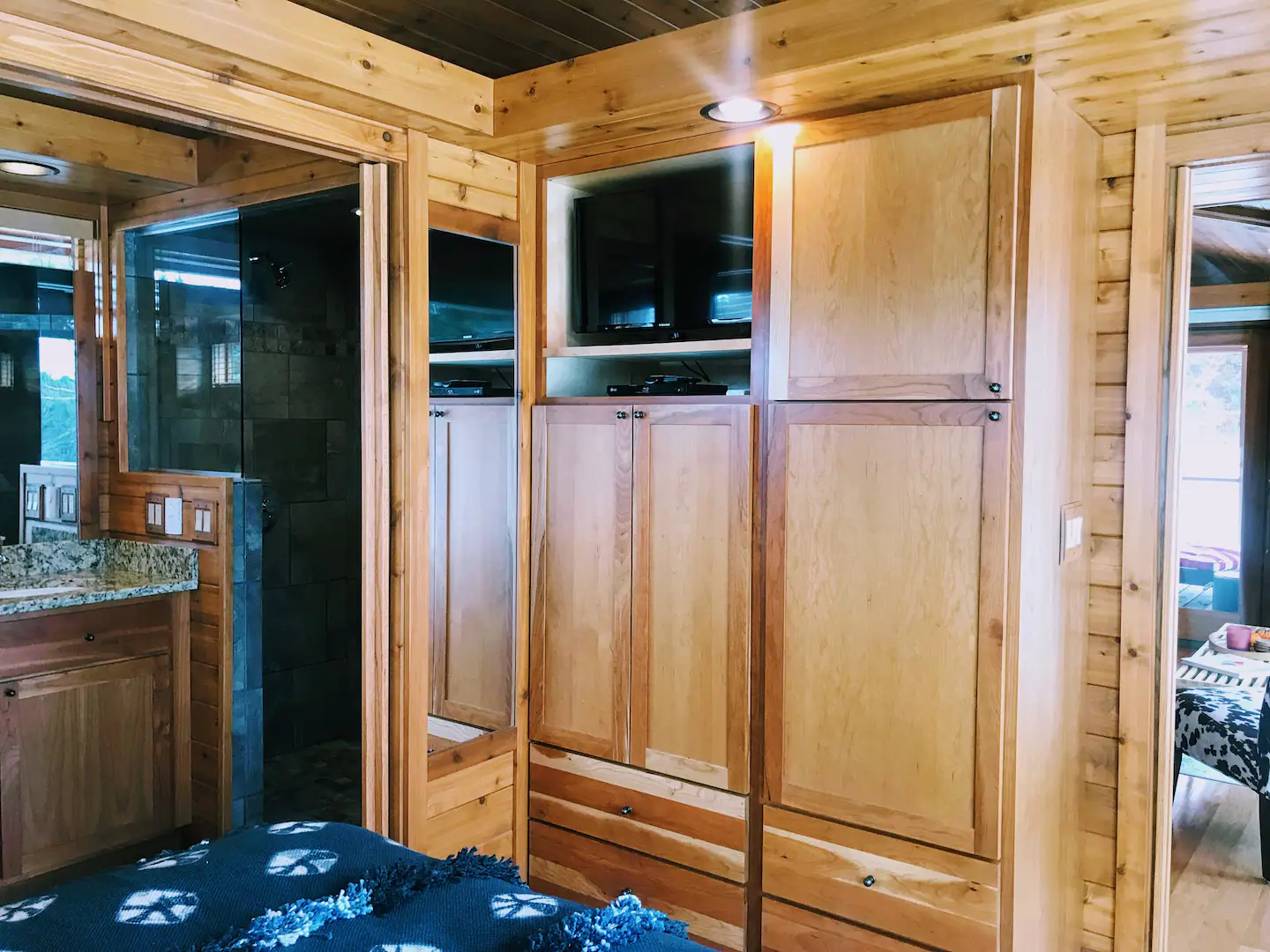 A big screen TV and a full length mirror are also included in the spacious cherry cabinets. Two huge, interconnecting pocket doors divide the bedroom from the bathroom.