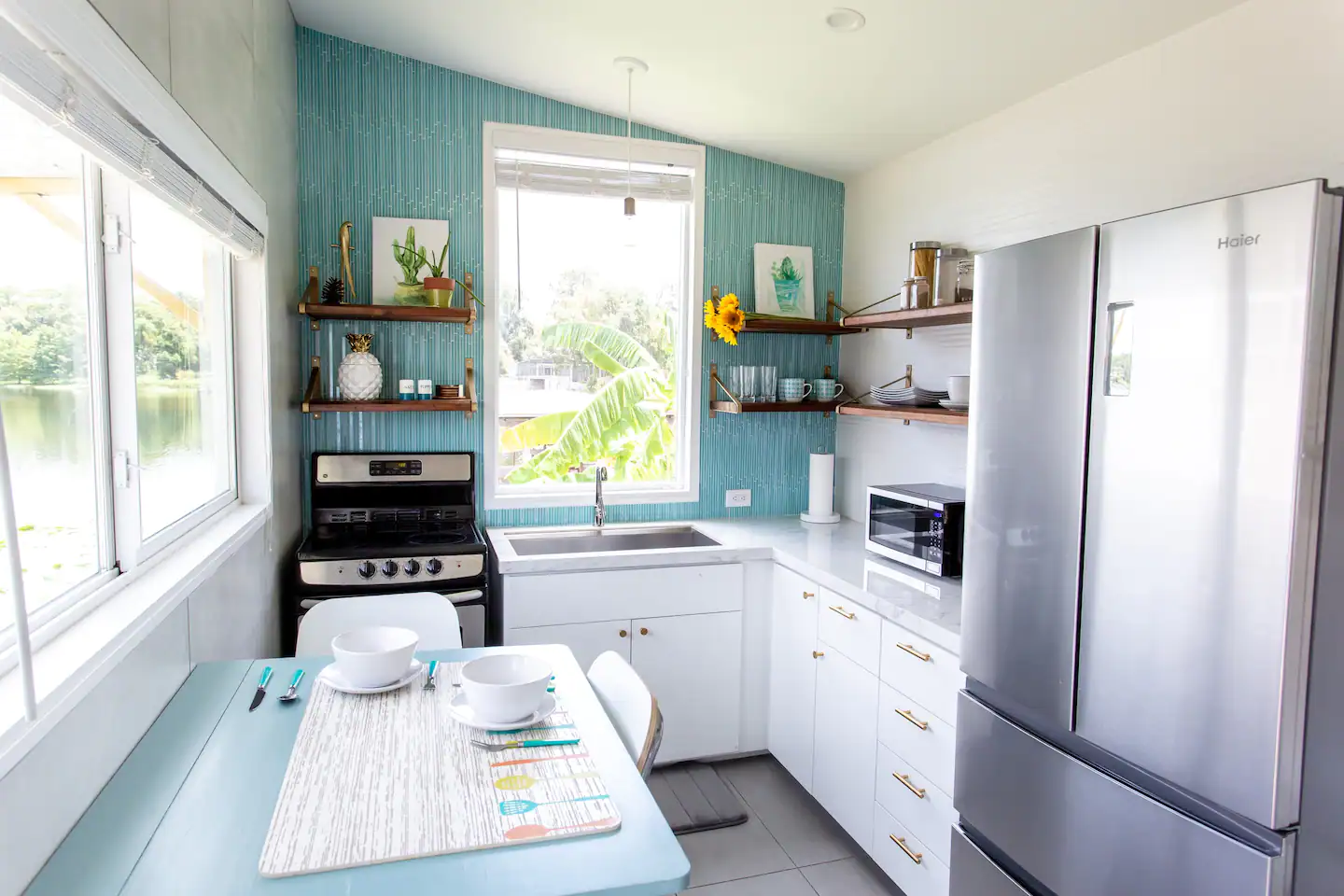 Kitchen is bright and tropical, with a full sink and oven.