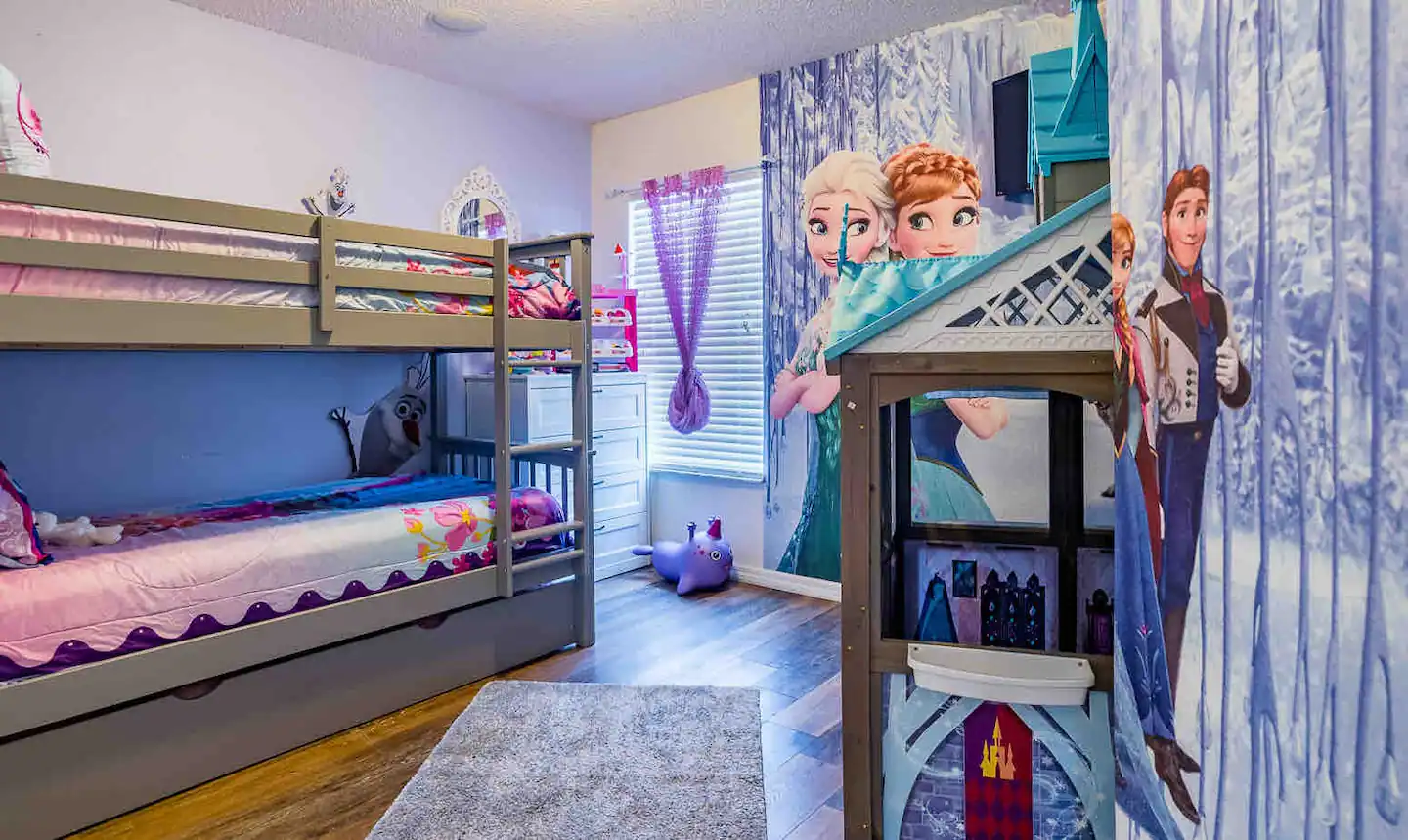 A Frozen themed room has a bunk bed and twin trundle