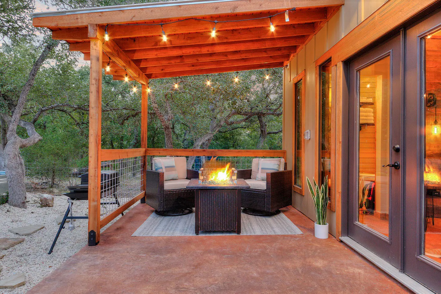 Enjoy a Texas evening on the porch with the fire table and twinkling lights.