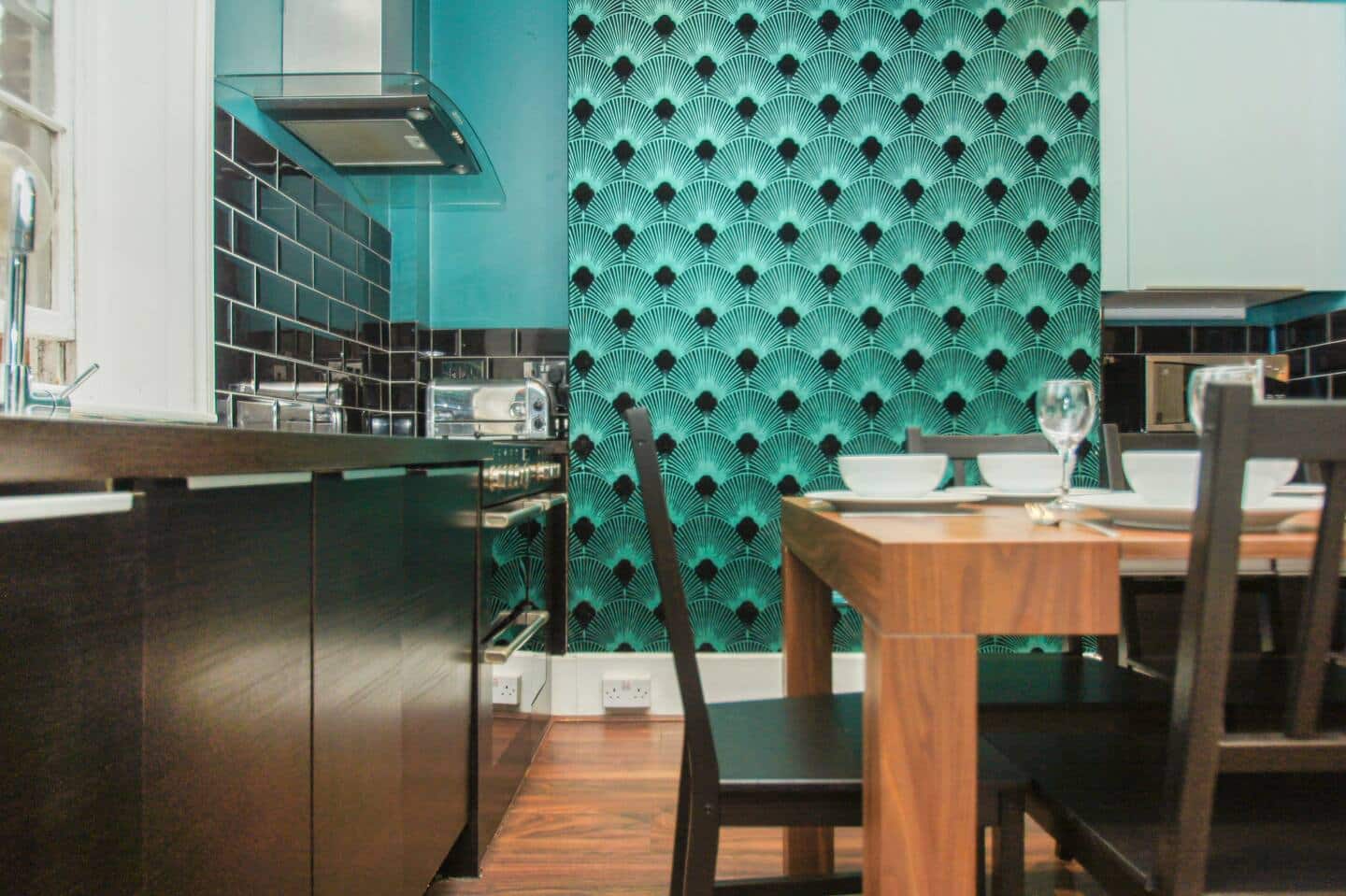 The wall paper design in the dining area is a feast to the eyes.