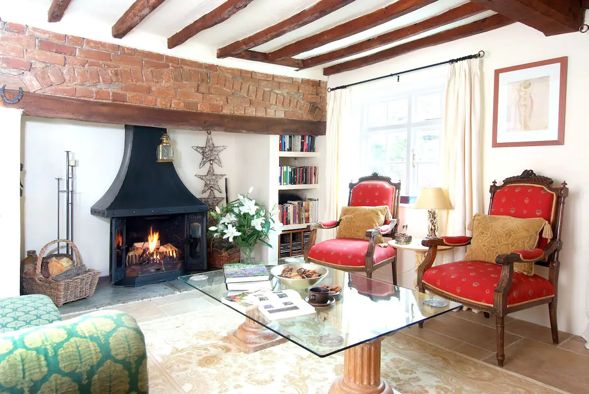 Beams abound in the living room, which is bright and airy in the summer and warm on a cold day sitting by the inglenook.