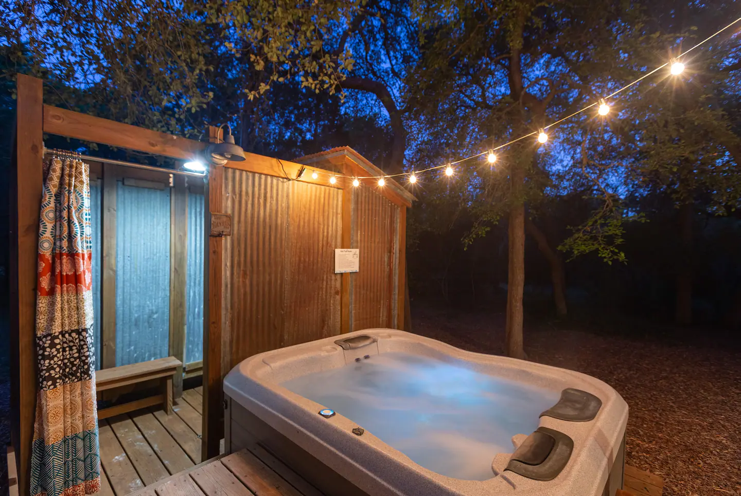 Next to the hot tub is an outdoor shower.