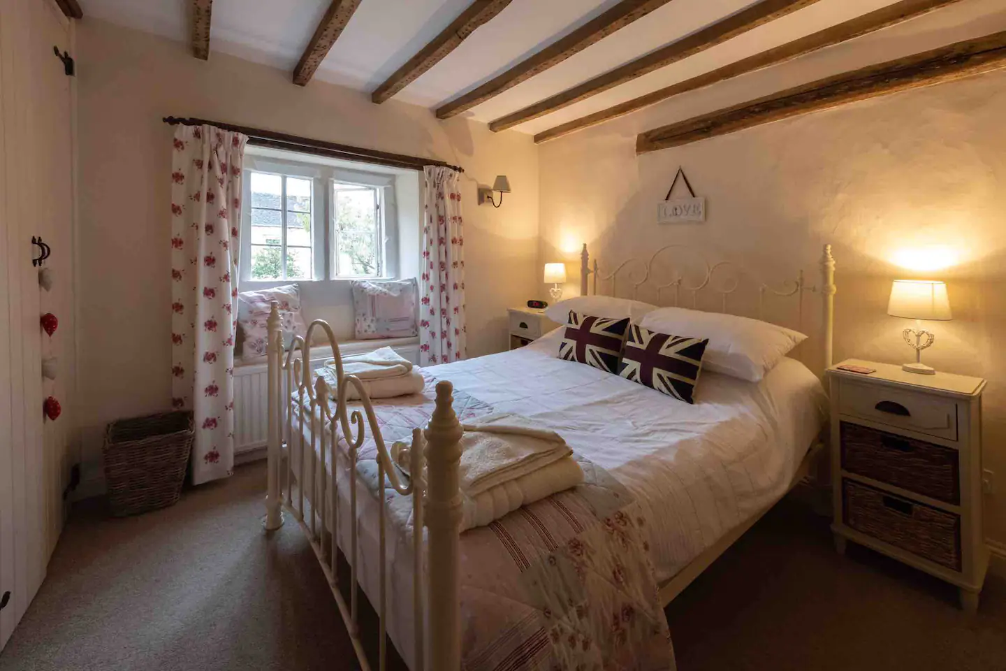 Beautiful double bed in a beamed chamber with a view of the Grade II listed Mullion window.