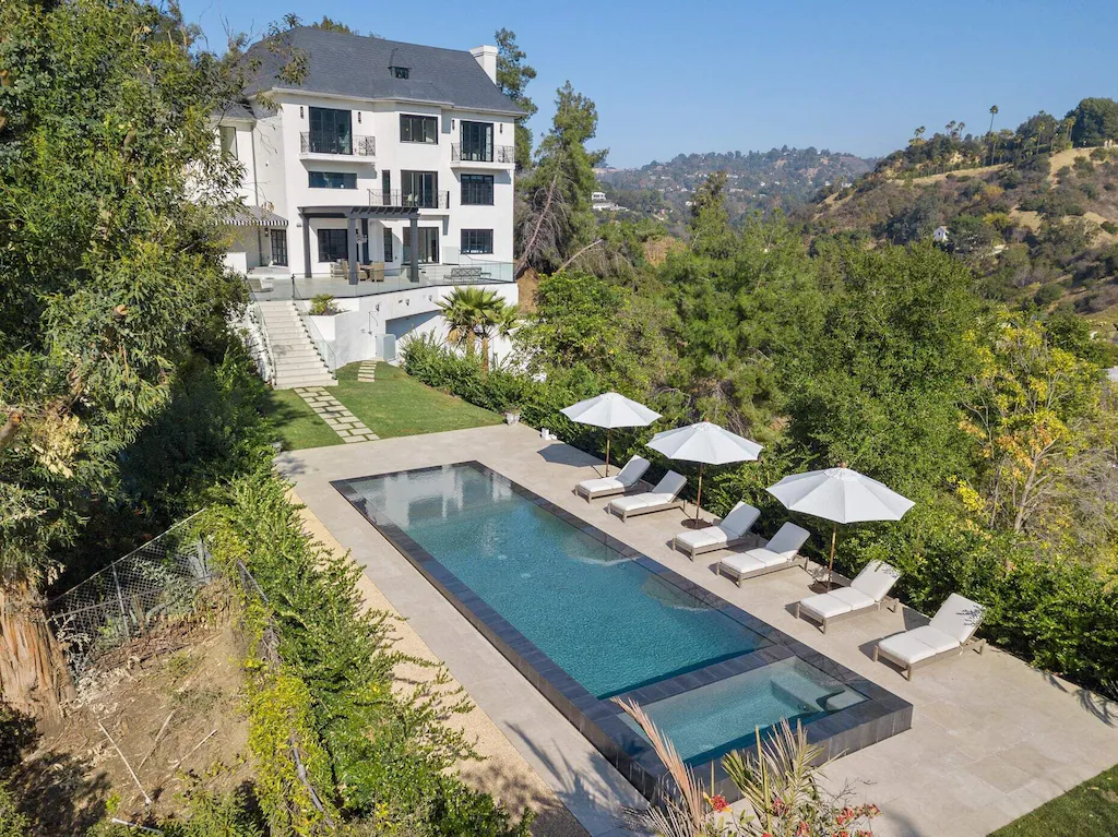 Pool with zero edge, sun deck, and jacuzzi, as well as a sunbathing lounge overlooking Beverly Hills.