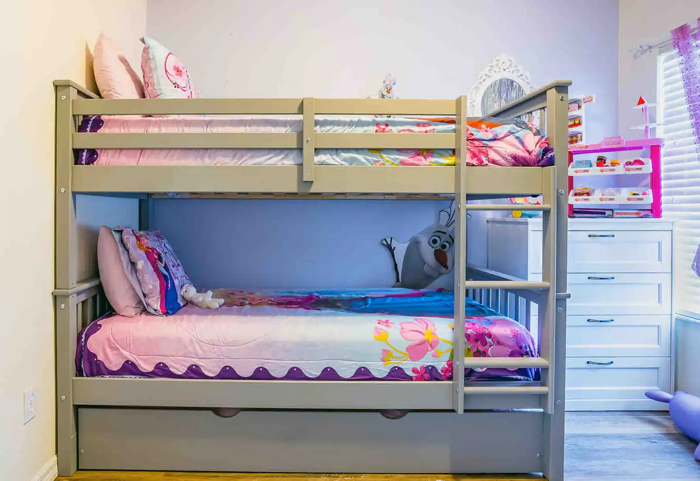 A bunk bed and twin trundle are included in a Frozen-themed room.