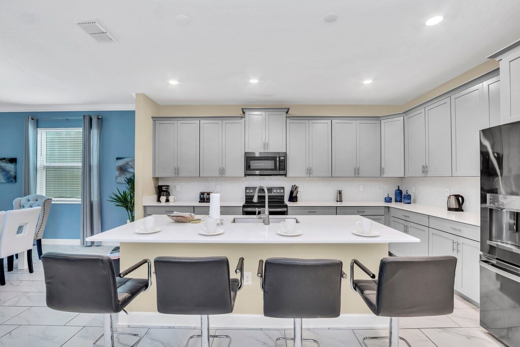 The kitchen is light and spacious, with all stainless equipment and all of the conveniences of home.
