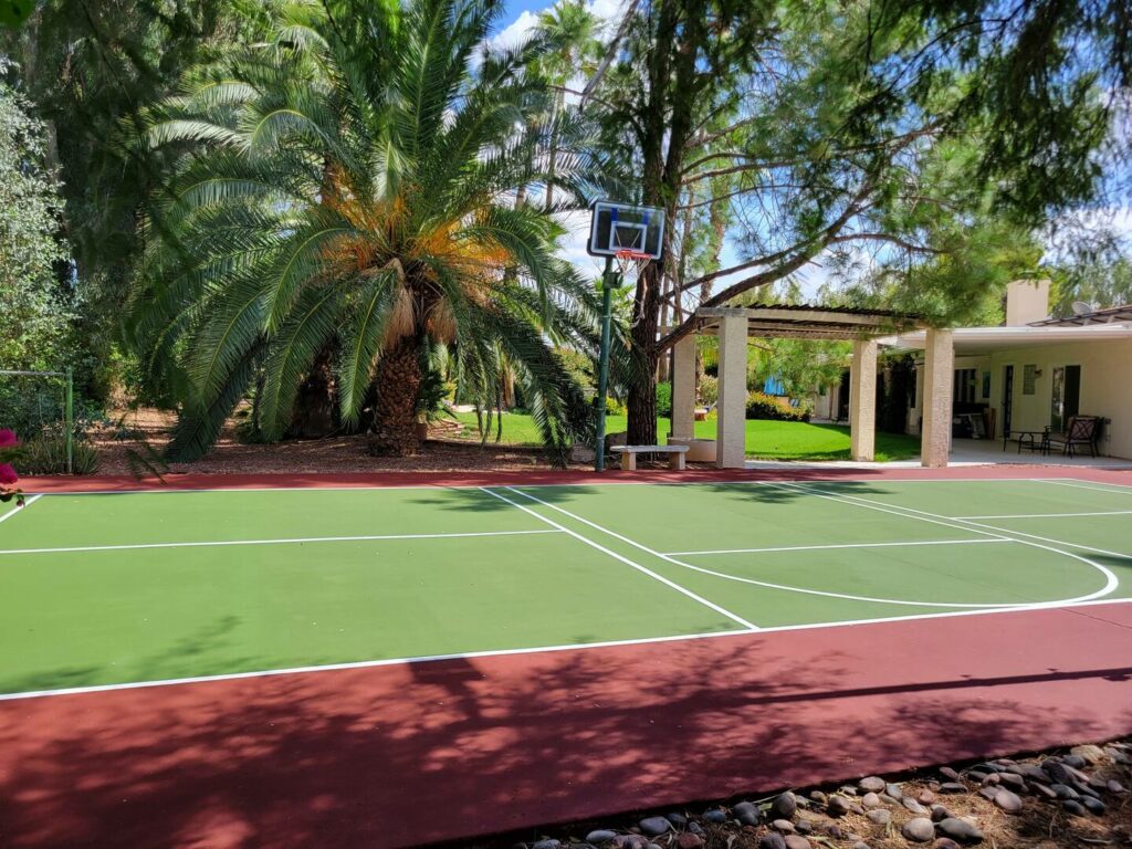 There is a spacious backyard with a private court for playing pickleball and basketball.