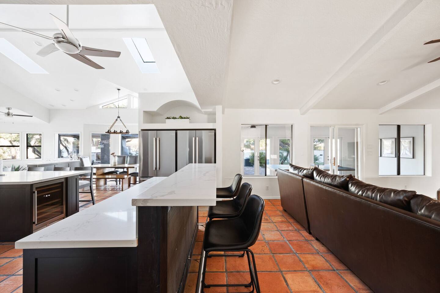 The kitchen boasts a large island with seating for three, perfect for gathering and enjoying meals together.