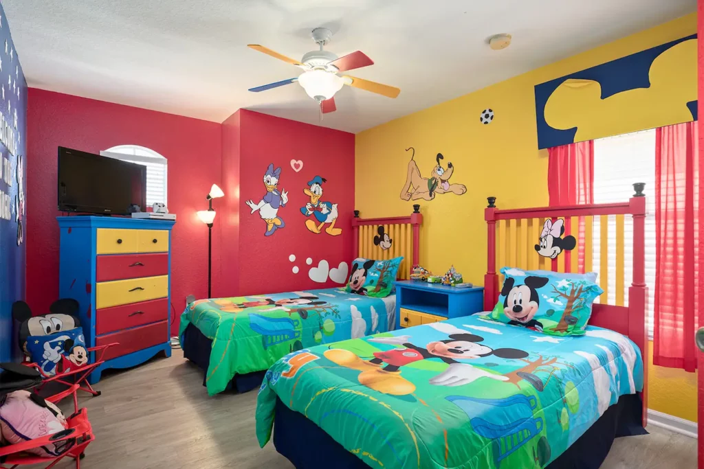 Mickey and Friends decorated children's bedroom with twin beds, 32-inch television, XBOX One with Kinect, and XBOX games

