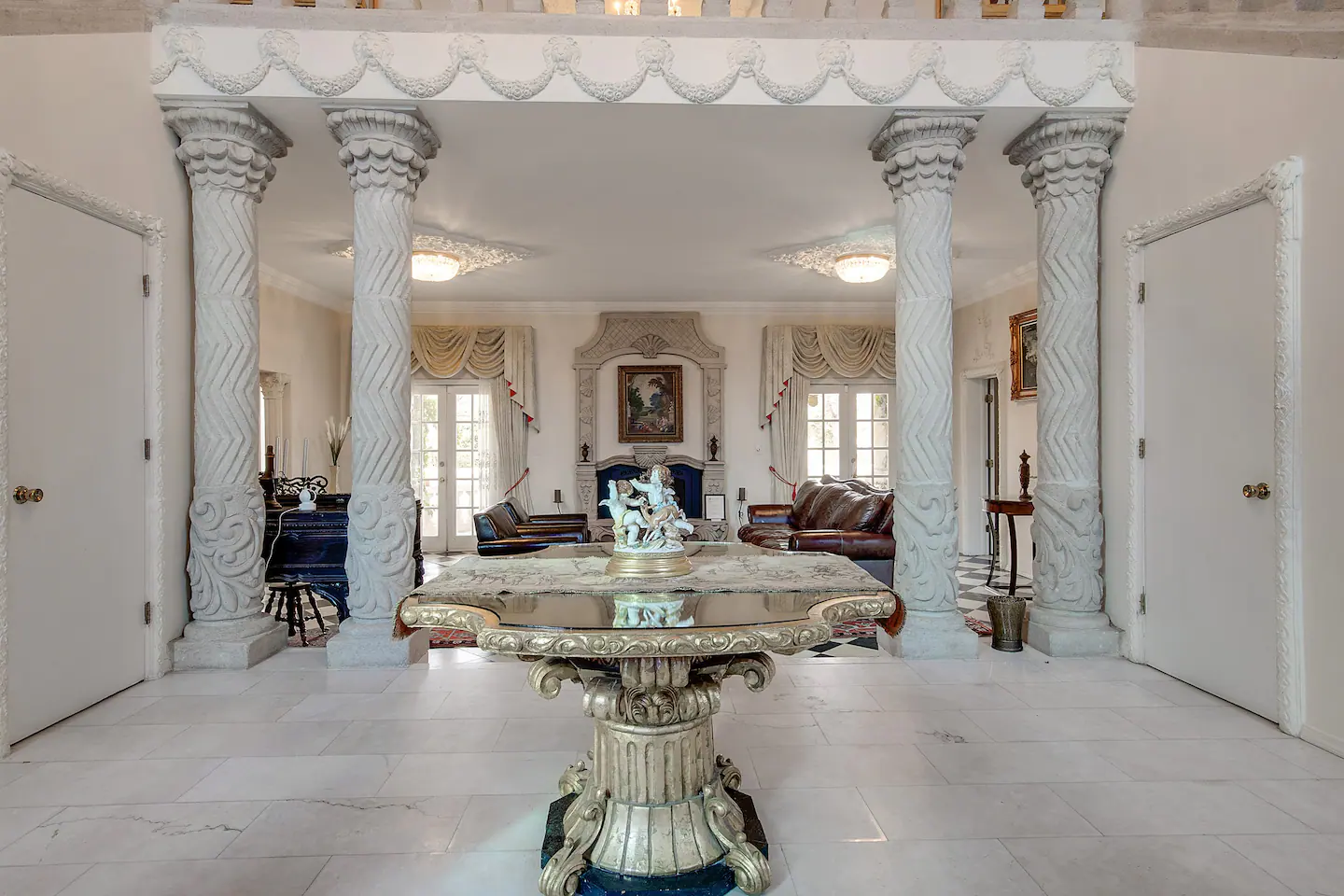 The Villa is a unique and elegant space adorned with beautiful paintings, marble and tile floors, ceiling murals, and decorative pillars.