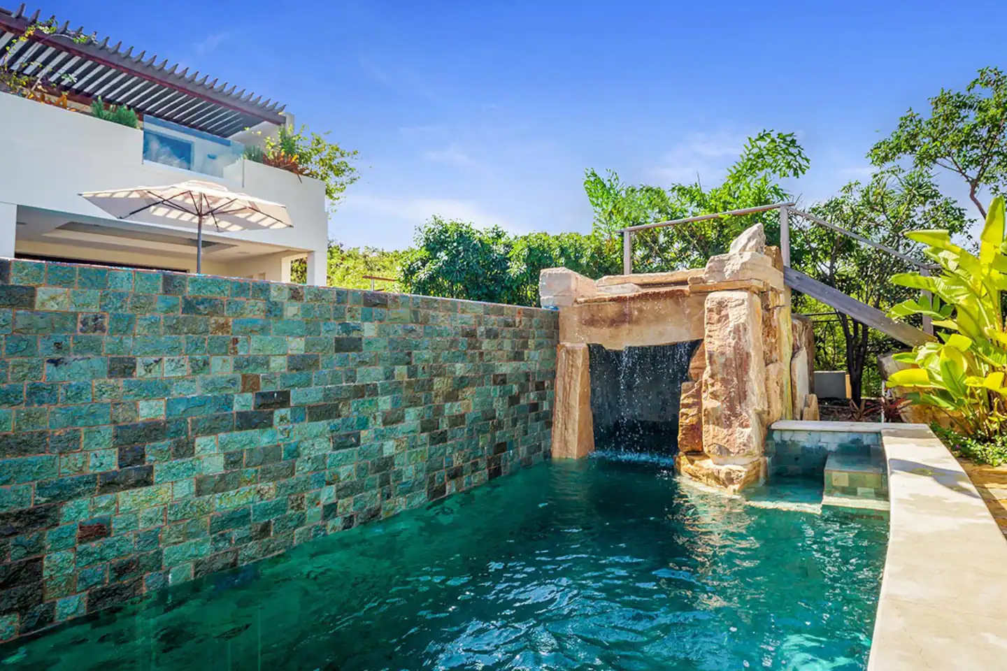 A stunning lower pool with a cascading waterfall.