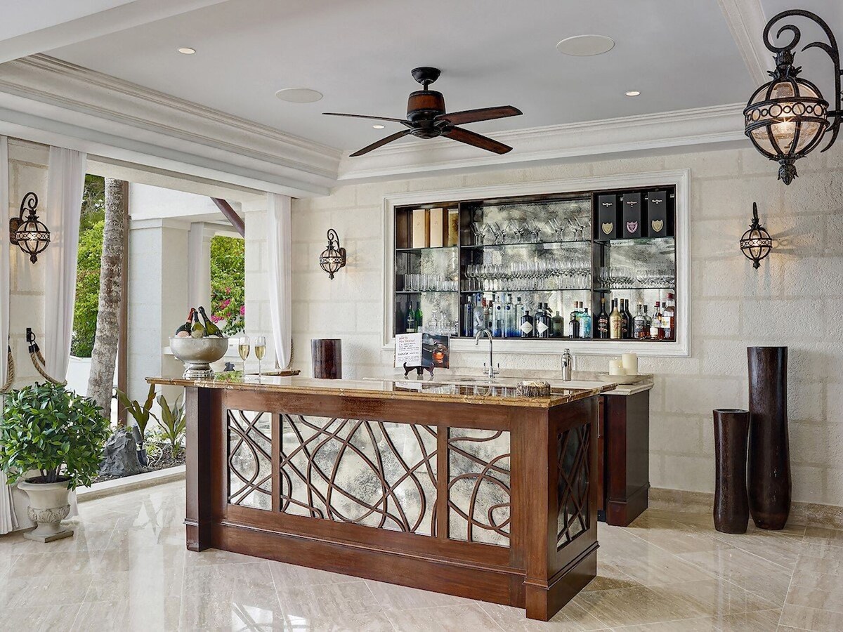 A modern kitchen bar with sleek countertops, state-of-the-art appliances, and stylish barstools.