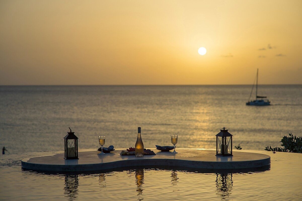 A luxurious infinity pool that seamlessly blends into the horizon of the beach.