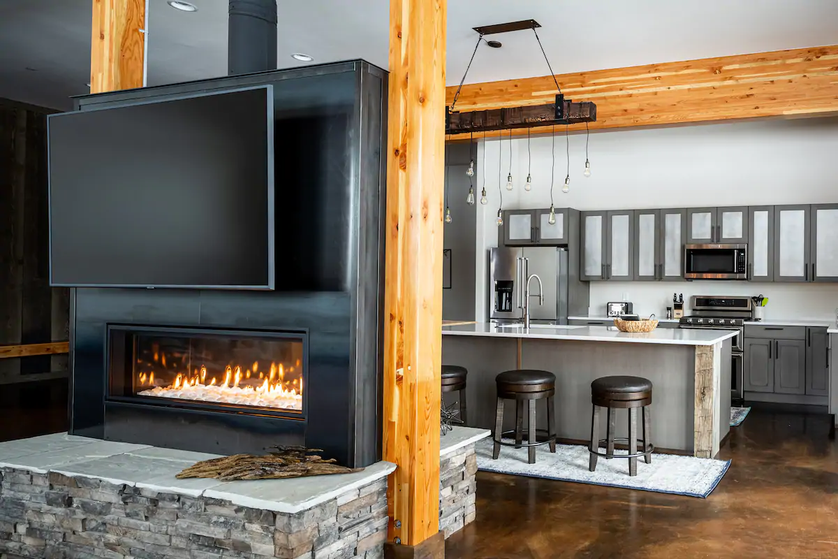 The fireplace provides warmth and ambiance, and the kitchen is well-equipped for any culinary creation.