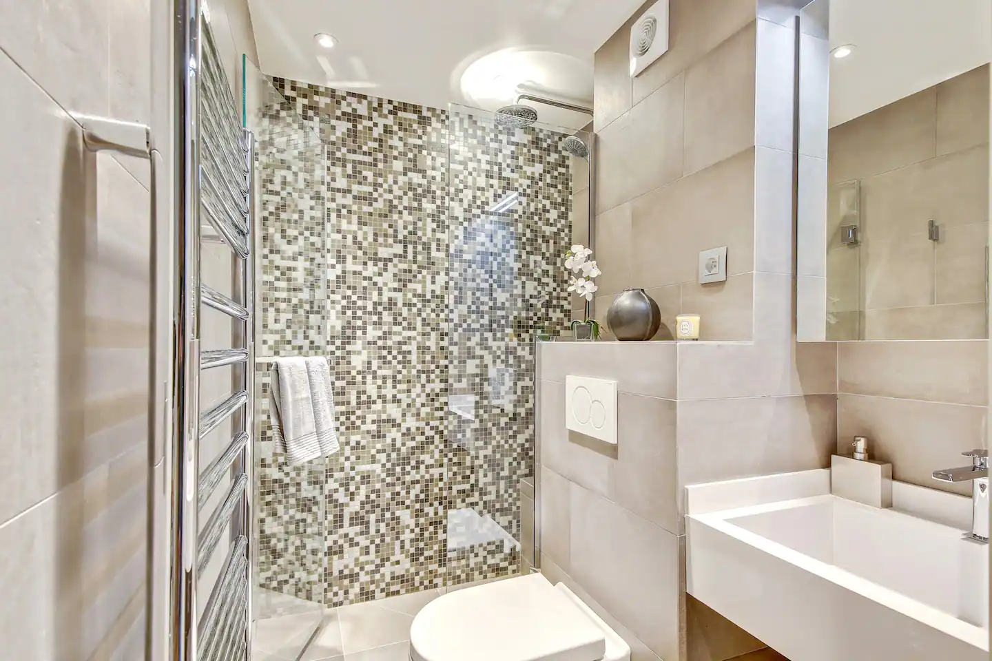 Bathroom features: sink, shower, toilet, shelves, tiled floor.