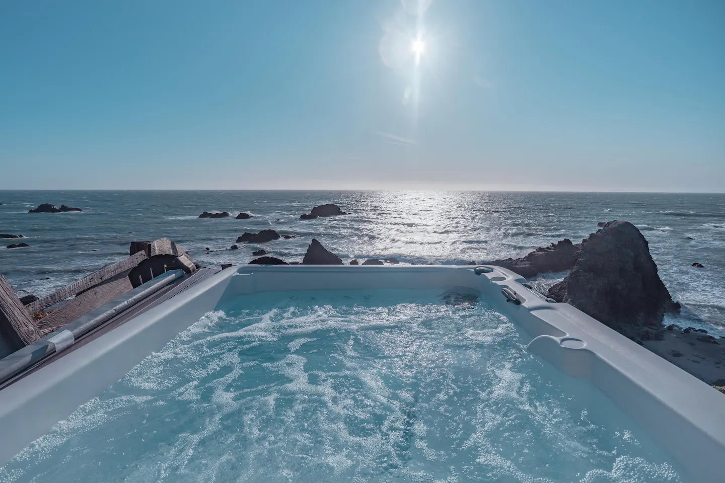 Enjoy your own private hot tub overlooking the cliff with panoramic views of the ocean