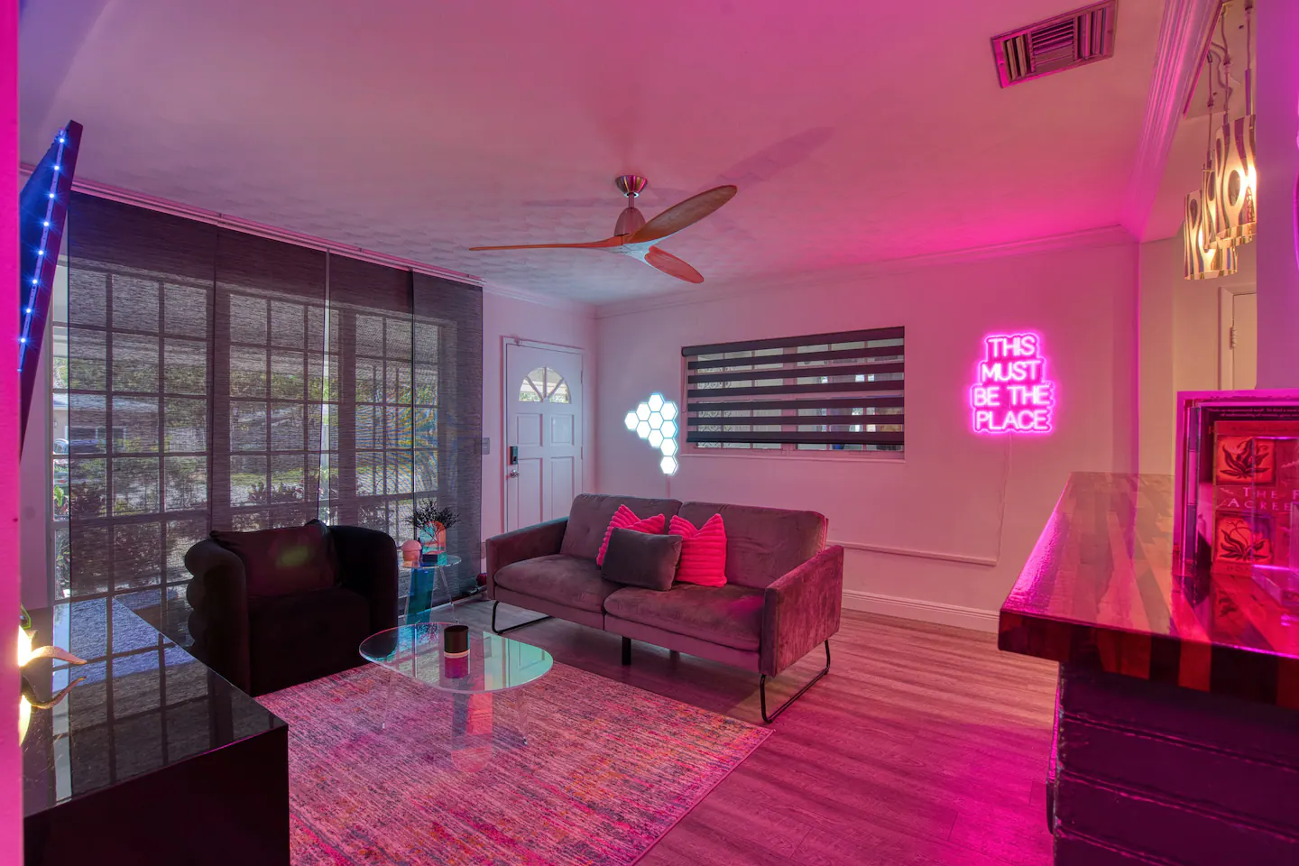 Chic and spacious living room adorned with neon lights for a more romantic feels.
