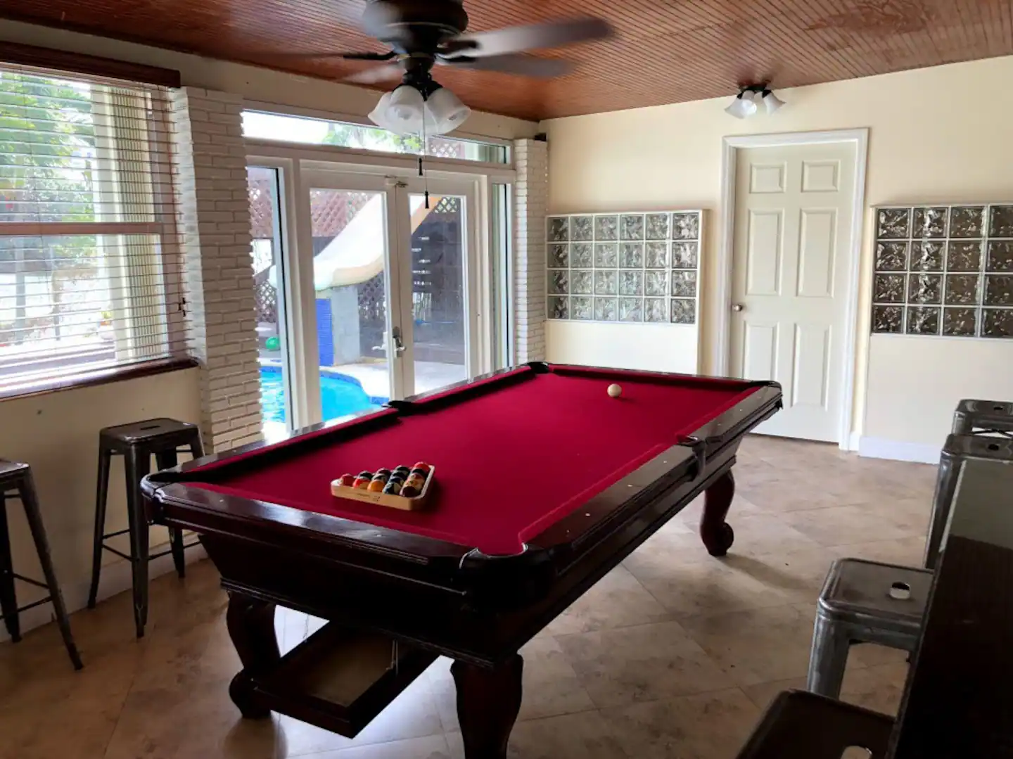 Game Room with Billiards Table overlooking Pool & Patio Area.
