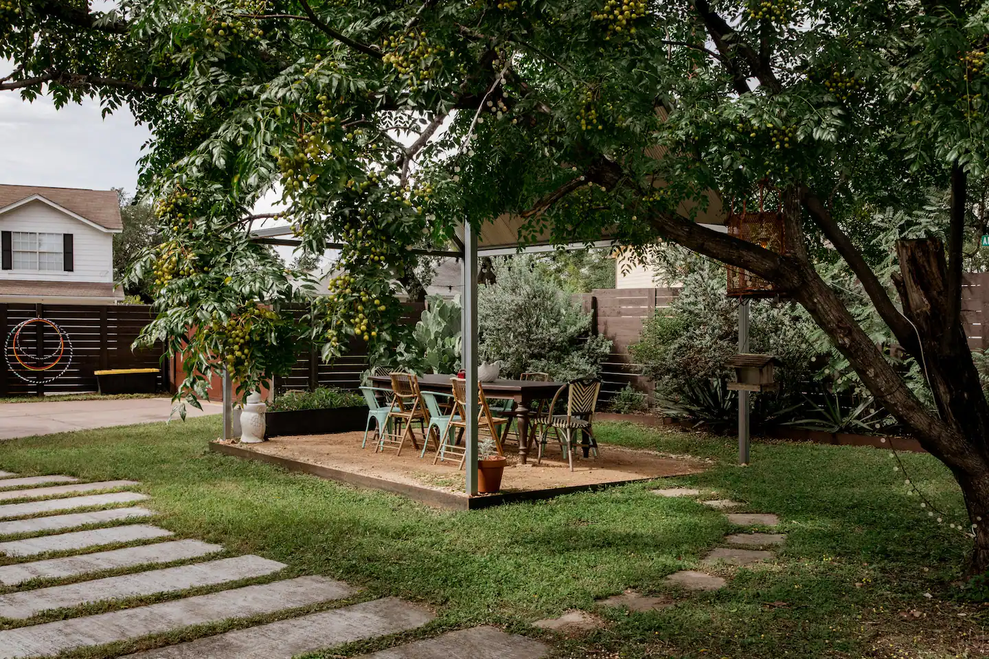 Our massive back yard includes a covered dining table, BBQ and a fire pit.