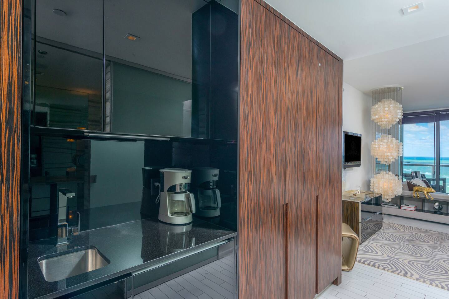 An efficiently designed kitchenette featuring sleek countertops.