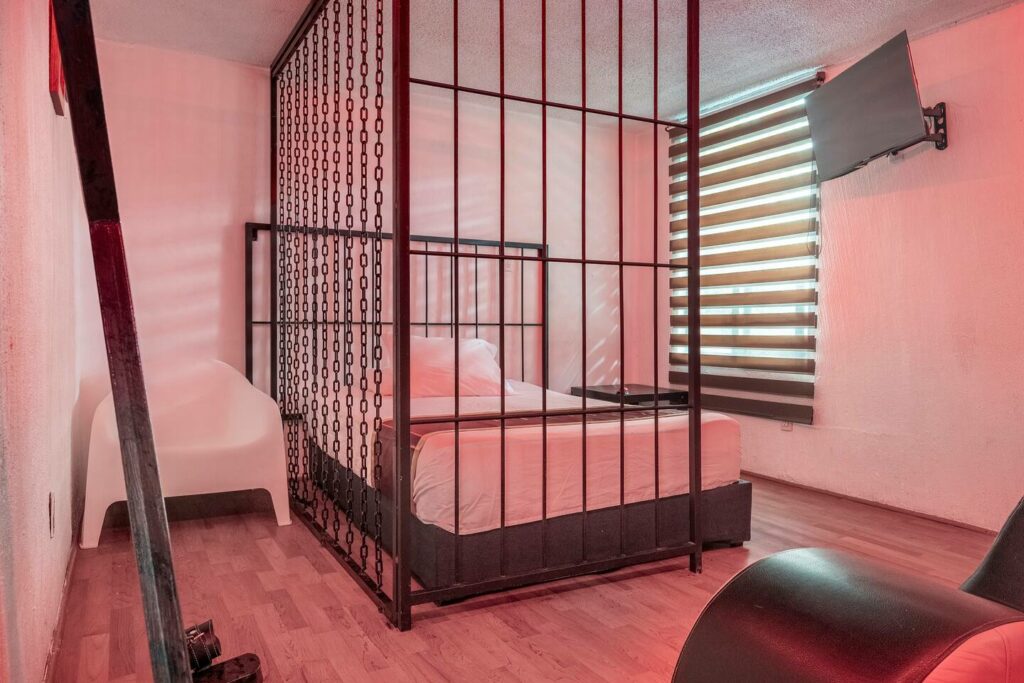 The owners provide unique decor to satisfy your desires, including a cage and a cross-shaped bed attached to the wall for bondage.