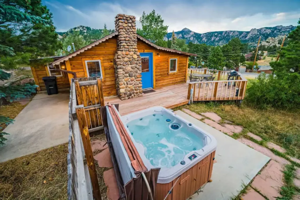Everything you need for a perfect vacation: hot tub, views, and a rustic cabin in the mountains.
